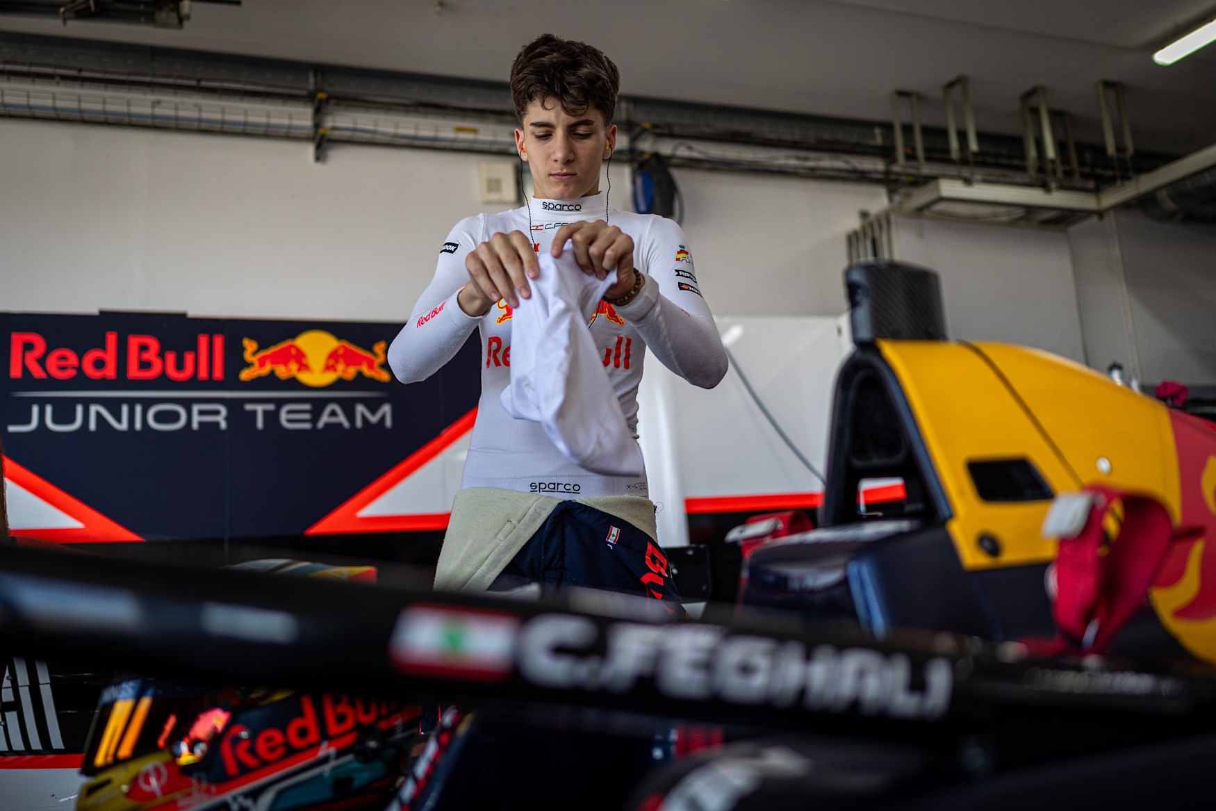 Lebanese racing driver Christopher El Feghali in his Drivex Eurocup-3 car at the Paul Ricard circuit, lifting the winner's trophy on the podium.