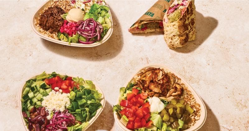 A row of Lebanese-style fast-casual bowls with chicken shawarma, rice, vegetables