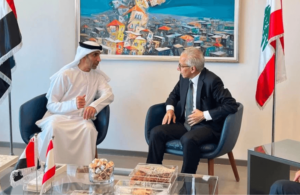 UAE Minister of State for Foreign Trade Thani bin Ahmed Al Zeyoudi in talks with a Lebanese official in Beirut, flanked by the UAE and Lebanon flags