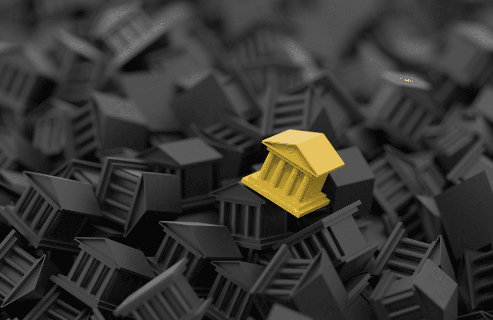 A single yellow bank building icon standing out among a dense pile of identical dark grey bank icons